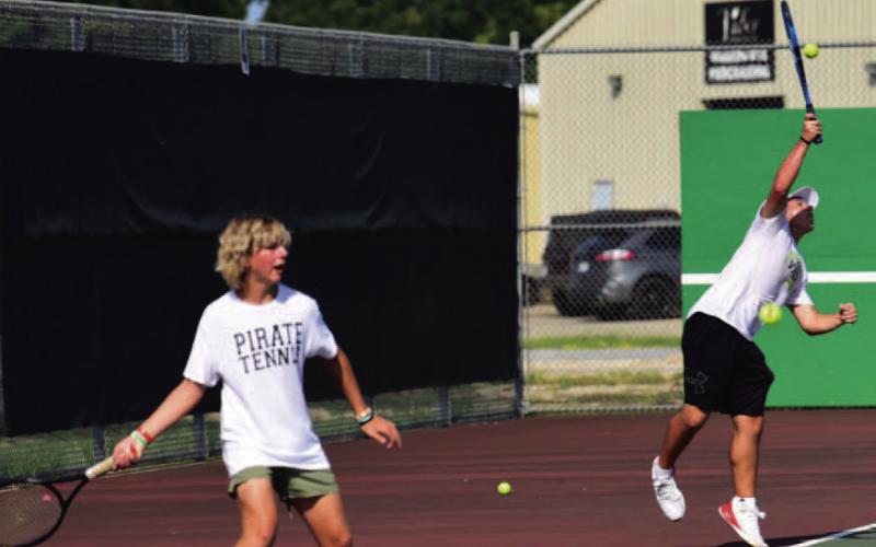 The tennis courts were filled Monday as Vidor Tennis hosted Goose Creek Memorial to open the 2023 season play. Boys’ singles competitors Gideon Rowe (sophomore), left, and Austin Gibbs,(junior), right, battle their opponents. Photo by Randall Luker