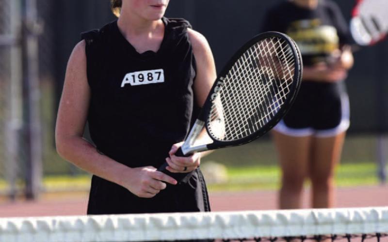 Katie Hanks shows her game face as she awaits the serve at the net, her partner, Mia LaPray, is pictured in the background. Photo by Randall Luker