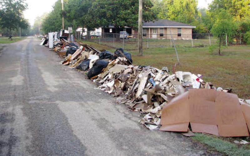 After paying with more than $10 million in local tax dollars for Hurricane Harvey Storm Debris removal for the last ten months, FEMA has agreed to reimburse Orange County soon for its efforts to pick up debris piles like this one in Pine Forest. Archive Photo