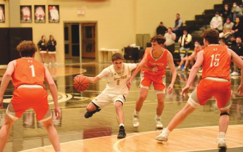 Nathan Bullard fends off Bobcat defender as he drives toward the goal.
