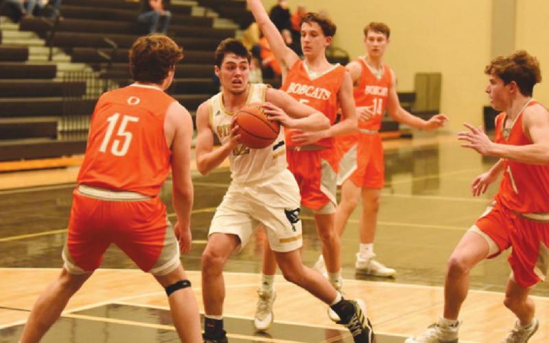 Surrounded by Bobcats, Pirate Dayton Whitmire hunts for an open teammate to pass.