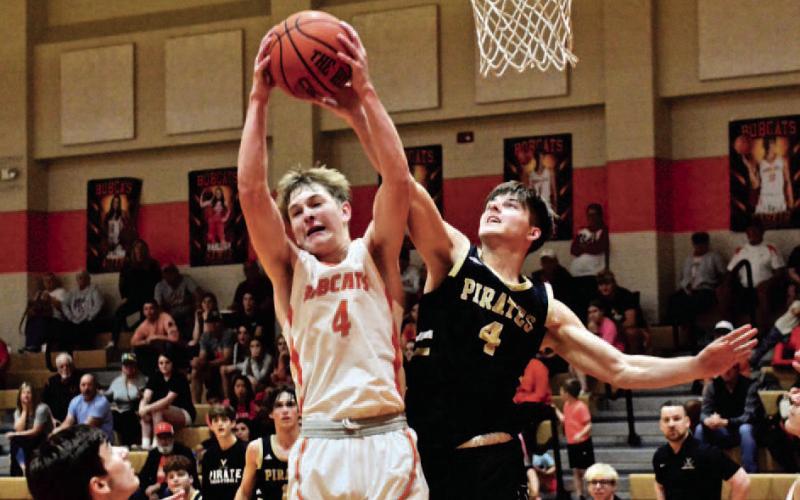 Dane Villadsen battles a Bobcat for the rebound Saturday at the Orangefield Hoops Tournament. Photo by Randall Luker