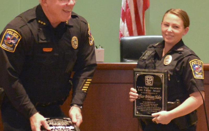 Vidor Police Chief Rod Carroll, left, presented Lifesaving Awards to three current or former Vidor Police Officers at an awards ceremony held at Vidor City Hall Tuesday. Shown received her Lifesaving Award plaque is Officer Brittany Haley. Photo by Randall Luker