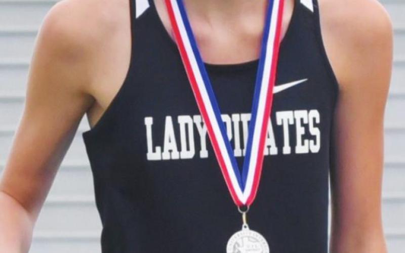 Jaden Lee smiles after receiving her medal for 2nd place in 100M hurdles.