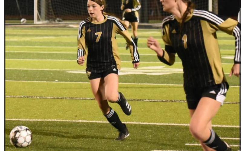 Lady Pirates Chloe Post, #7, and Jaden Lee, #1, team up to move the ball into scoring position versus Cleveland. Photo by Randall Luker