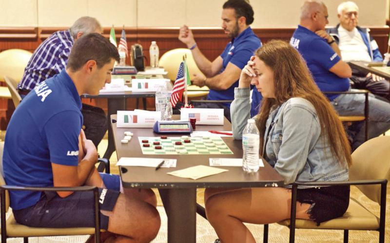 Team USA’s Tetiana Zaitseva and Team Italy’s Davide Gemma concentrate on the playing board during their match Tuesday at Vidor City Hall.