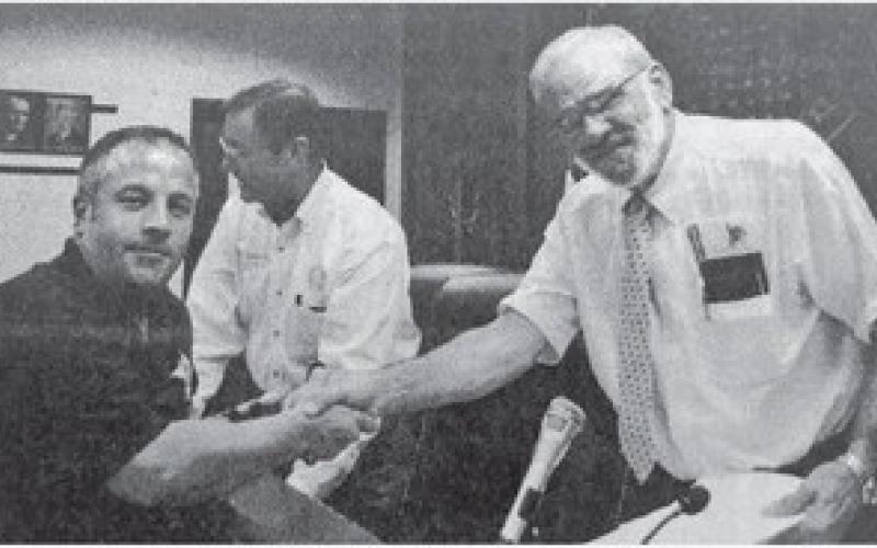 Orange County Judge Carl Thibodeaux, right, and the Orange County Sheriff’s Office Employee Association negotiator Lt. Tom Ray, left, had smiles on their faces as they shook hands after the Commissioners Court tentatively agreed to the union’s contract offer on Monday.