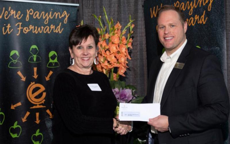 Sally Andrews, Director of Community Relations, VISD, receiving checks for Vidor Junior High and Oak Forest Elementary
