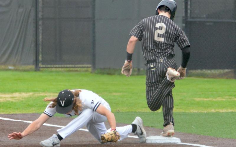 Pirate first baseman Reagan Hallmark stretches to make the play at first in Vidor’s BC tournament game versus Nederland Photo by Randall Luker