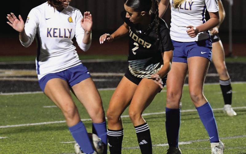 Taylor Bull slips the ball past a Kelly defender and then scores in Friday’s match.