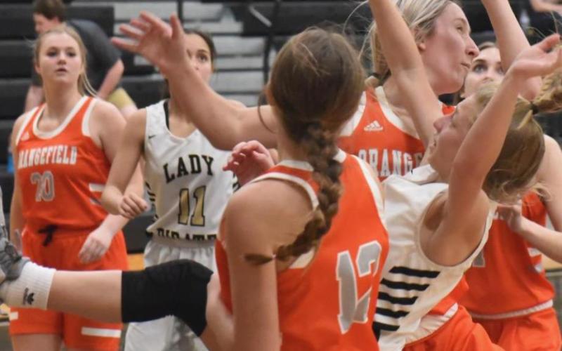 Lady Pirate Mia Robin is upended as she shoots in Tuesdays district game versus Orangefield. Photos by Randall Luker