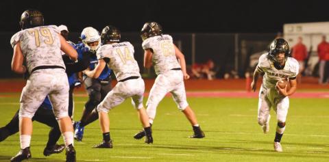 Pirate QB Quinten Root runs for a first down behind a screen of blockers, #79 Tyler Webb, #14 Jason Watson and #65 Bryce Munoz.