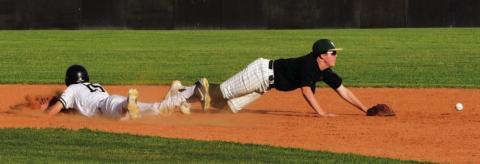 Alex Parish, diving headfirst into second base, is safe after a throwing error. The junior varsity defeated the LCM Bears in Vidor. Photos by Randall Luker