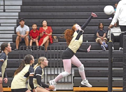 Ashlyn Martin jumps for a return against West Brook Tuesday in Pirate Gym.