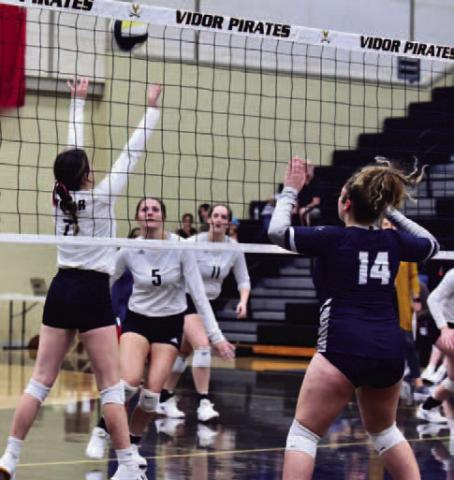 Brilie Cornelison #7 sets the ball for Madison Powell #5 in the Lady Pirates home district opener versus WOS.  Photo by Randall Luker