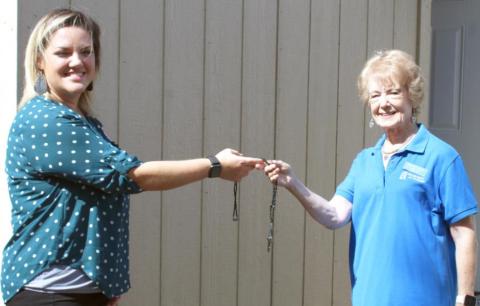 Laura Roberts, Team Leader of Leadership Southeast Texas Orange County Team #1 presents the key to a new storage building to Clara Fults, Assistant Director at Birthright of Orange.