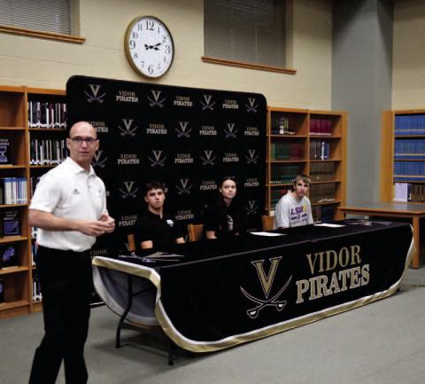 VISD Athletic Director Dwayne DuBois introduces Daigan Venable, Madison Perkins and Caden Williamson at the college signing ceremony held in the VHS Library Friday.