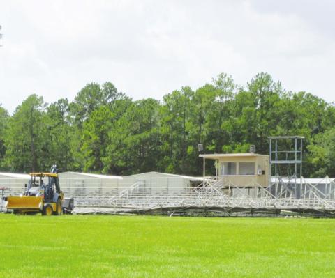 The high winds of Hurricane Laura picked up one entire section of bleacher seats at the Vidor Junior High football field, flipped it over and tossed them onto the playing turf. At the temporary Oak Forest Elementary School campus Laura’s fury ripped off a whole section of center walkway awning that workmen have already replaced. Photo by George Garza