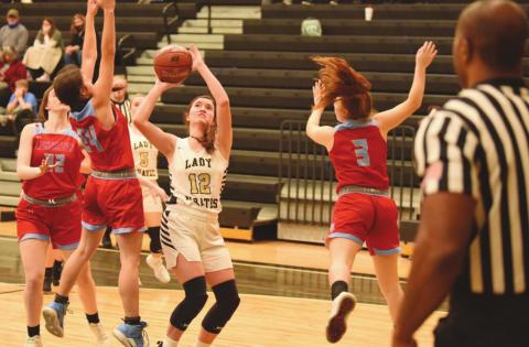 Ava Lightfoot keeps her eye on the goal as she shoots between two Lady Raiders.
