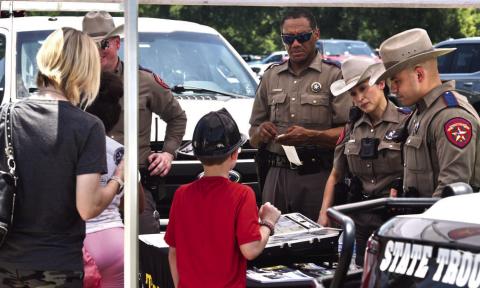 Sergeant Richard Standifer and Troopers Alt, Arauz and Salinas manned the Texas Department of Public Safety booth at the Cops N Kids event answering questions, handing out pamphlets and interacting with parents and kids.
