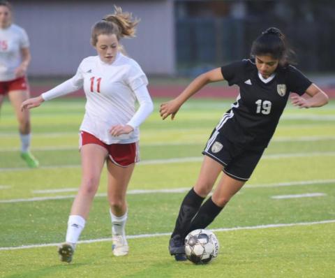 Junior Varsity Lady Pirate Catherine Gaspar dribbles past a Cleveland player Tuesday at pirate Stadium. Gaspar scored Vidor’s lone goal in a 9-1 loss. Photo by Randall Luker
