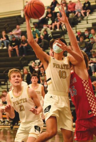 Aiden Ochoa, #10, takes a shot as #23, Easton Walker watches for a rebound. Dayton Whitmire is in the background. The Pirates lost 57-44.