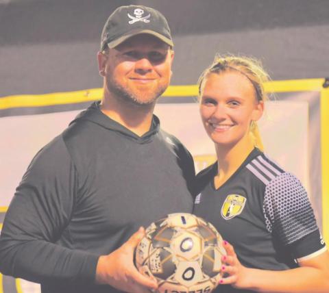 Brooklyn Healy with Coach Ralph Fields after scoring her 100th career goal.