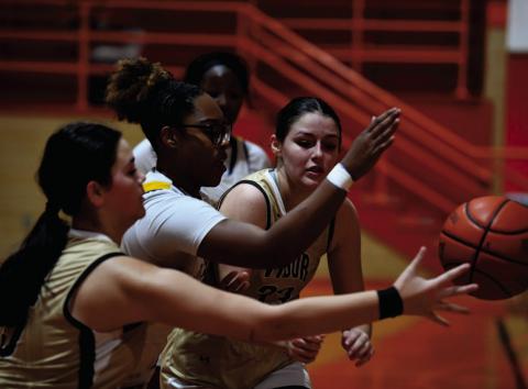 Kinsey Dillard, foreground, and Aubri Frasier battle for control under the basket versus LaMarque.