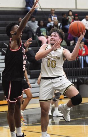 Camden Young attempts a one-handed under the basket.