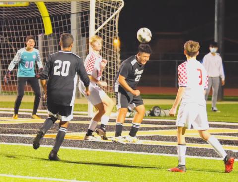 Varsity Pirates Aaron Guevara, #23 and Fidel Nava #20 work the ball at the Raider goal following a corner kick