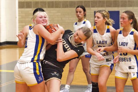 Battle for possession Vidor’s Raegan Stephenson battles with an Evadale Lady Rebel for possession of the ball during Tuesday night’s varsity game in Evadale. The Lady Pirates begin district play Friday in Lumberton.