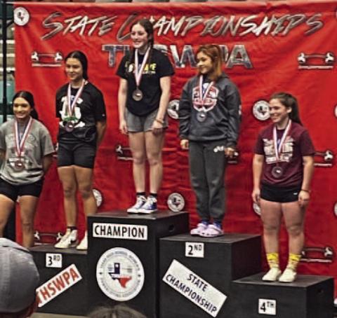 Camryn Barragan, center, set a new state record with a 250 pound lift in bench press in the 123 weight class at the Girls State Powerlifting Meet last week. the previous record was 215 pounds. Vidor’s team placed 4th at the state meet. Photo by Randall Luker
