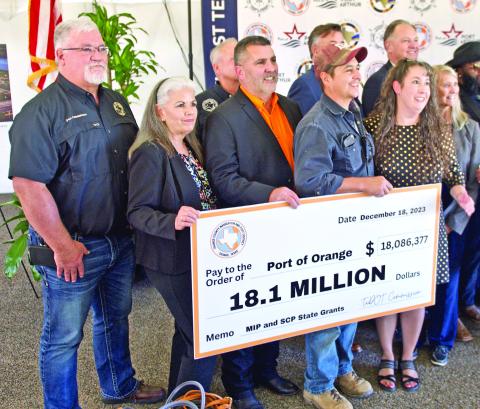 Port of Orange officials hold a facsimile check representing the historic $18.1 million in state funding that will repair and improve port facilities. Southeast Texas ports will share in a total of $66 million in state grant funding to improve port infrastructure.