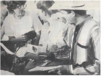 Country and western recording artist Tracy Byrd signs autographs for Community Choir members prior to the start of the Thumbs Up, Vidor rally Saturday night. Byrd gave an hour concert as part of the rally that promoted pride in being from Vidor.