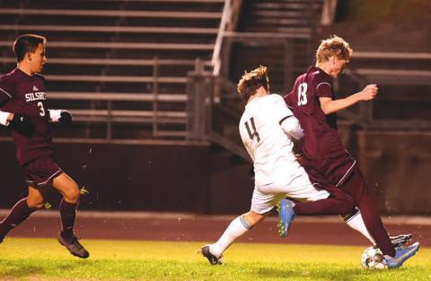 Alex Ramos battles a Silsbee Tiger for possession. Photo by Randall Luker