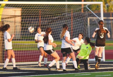 Lady Panthers watch as Lady Pirate Maryn Chilton’s, right #3, kick sails by for Vidor’s third goal in their playoff game Thursday.