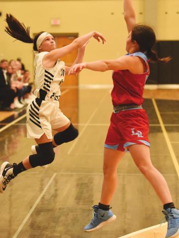 Taylor Waguespack take a shot over a Lumberton Lady Raider in the Lady Pirates final game of 2019. Saturday, the Lady Pirates host the Lady Cougars of Buna at Pirate Gym to kick off 2021 competition.
