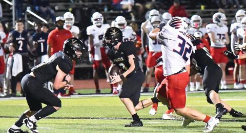 Landon Jones breaks into the open as Brody Bloss prepares to block his pursuer.