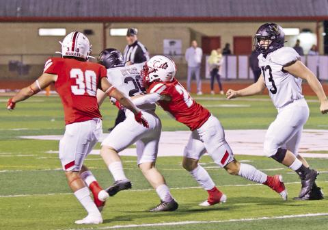 A pair of Wildcat defenders find it tough to tackle Pirate fullback Riley Marlow.