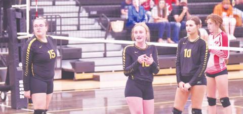 Lady Pirate junior varsity players 15-Ashlee Malagarie, 16-Natalie Morrison and 10-Andreya Garrett look to the sidelines during a break in the action Friday night versus Deweyville.