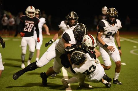 Jordan Smith and Connor McKay, #33, wrap up a Falcon ball carrier for a loss of yardage. Photo by Randall Luker