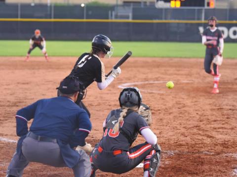 Brooklyn Bushelle pivots for a bunt in the varsity Lady Pirate softball game Thursday.