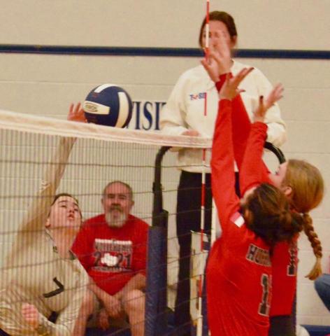 Lady Pirate Brilie Cornelison attempts a return over the outstretched arms of two Lady Falcon defenders. Photo by Randall Luker