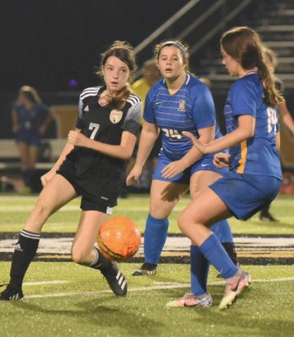 Freshman Lady Pirate Chloe Post looks to pass the ball to an open teammate. Photo by Randall Luker