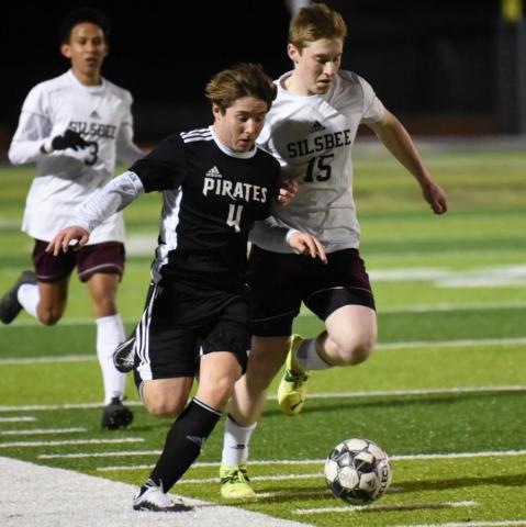 Vidor’s Alex Ramos races down the sideline with a Silsbee player in close pursuit in the Pirates’ home district opener last week. Photo by Randall Luker