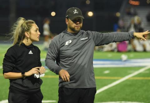 Head Coach Ralph Fields and assistant coach Ciera Tinkle discuss the game at the half. Photo by Randall Luker