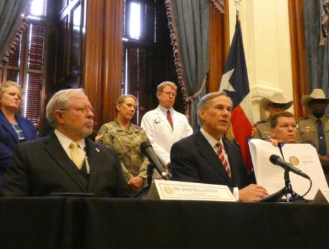 David Fleeger, MD, (in white coat) listens as Gov. Greg Abbott declares a state of emergency over COVID-19 in March, 2020. Courtesy Photo