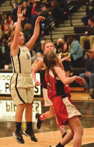 Lady Pirate Cassidy Callarman takes a shot over two Bridge City defenders in the 8B game.