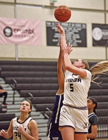 Vidor’s Raegan Stephenson shoots from under the basket in Friday’s 62-48 district win over the WOS Lady Mustangs as. Madison Perkins watches for the rebound.