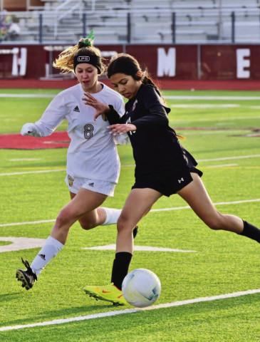 Natalie Domec closes in on a Jasper player in Friday’s away game at Jasper. Photo by Randall Luker